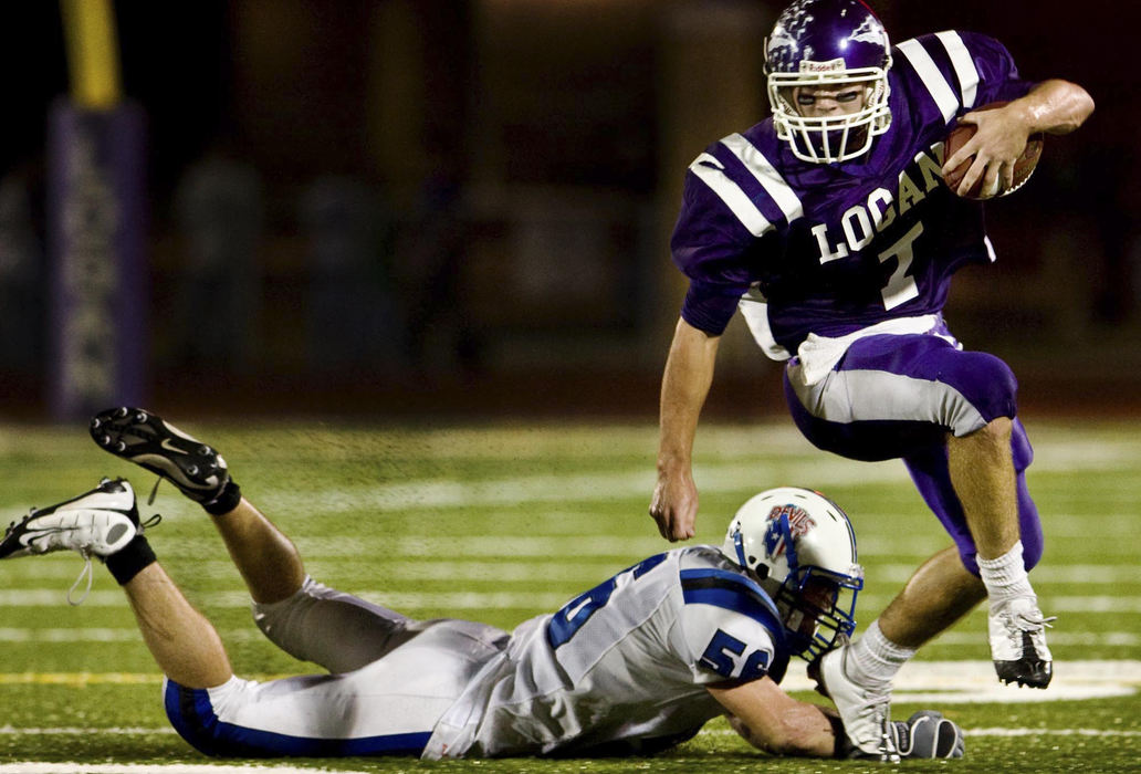 First Place, Student Photographer of the Year - Diego James Robles / Ohio UniversityLogan star-quarterback, Patrick Angle (7), evades a tackle from a Zanesville linebacker, James Fowler (56), during a long and ultimately successful drive by the Chieftains.