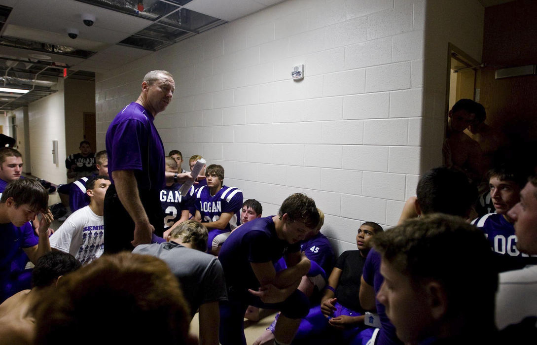 First Place, Student Photographer of the Year - Diego James Robles / Ohio UniversityHead coach, Dale Amex, hesitantly congratulates his football team after their first competitive game of the season; they narrowly beat Zanesville, 16-14.