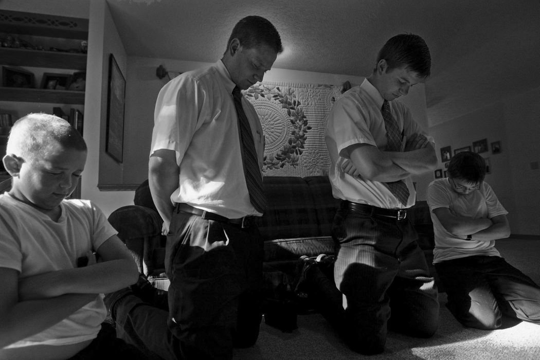 First Place, Student Photographer of the Year - Diego James Robles / Ohio UniversityChurch members, (left) Abe Ogle, 10 and his brother Sam Ogle, 12, pray with (left) Elder Merrill and Balls after dinner, in Athens.
