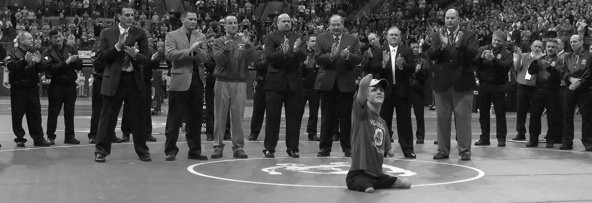 First Place, Sports Picture Story - Michael E. Keating / Cincinnati EnquirerCalled to the arena floor to be honored and inducted into the wrestling hall of fame, Dustin Carter was cited for his spirit and courage in his efforts to make the state tournament and achieved much more in " inspiring athletes".  