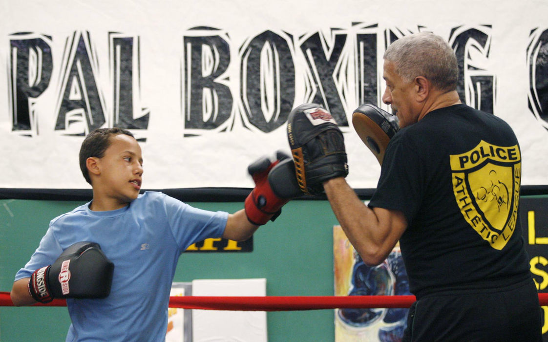 Second Place, Sports Picture Story - Andrea Kjerrumgaard / The Columbus DispatchTerrell Fairrow practices his mitt work with coach Bob Patterson during practice April 21, 2008, at the Police Athletic League in Chillicothe. 