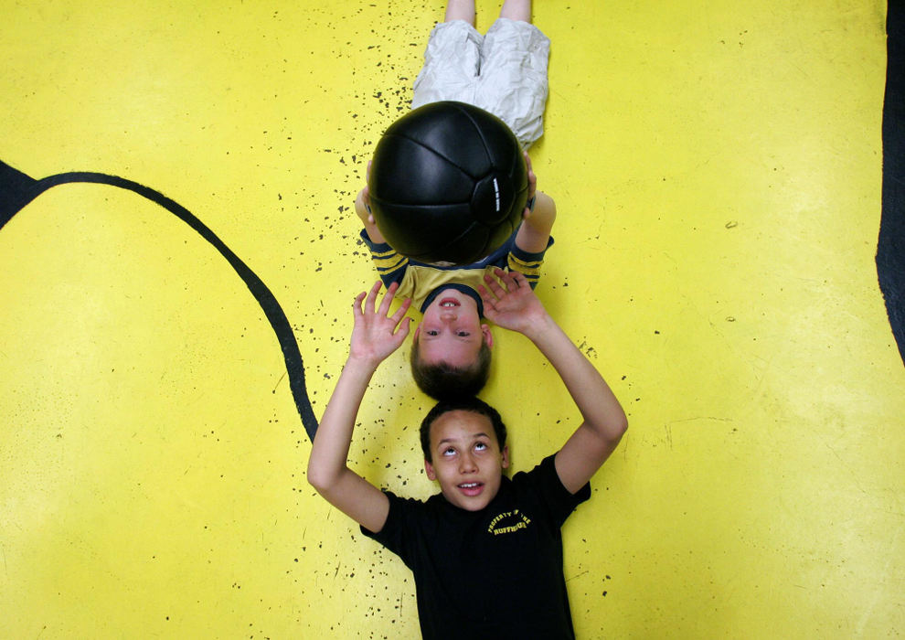 Second Place, Sports Picture Story - Andrea Kjerrumgaard / The Columbus DispatchTerrell Fairrow, 11, passes a medicine ball with his teammate Cain Childers, 9, during boxing practice March 10, 2008, at the Police Athletic League in Chillicothe.