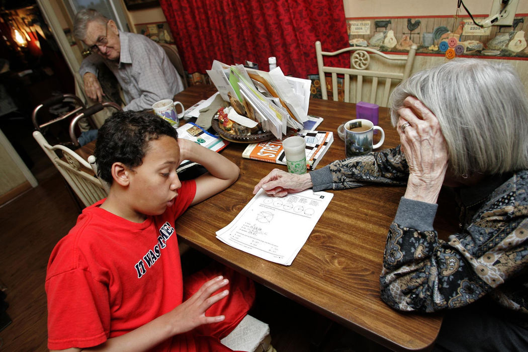 Second Place, Sports Picture Story - Andrea Kjerrumgaard / The Columbus DispatchFairrow's great grandmother Jean Rayer helps him with math homework March 30, 2008, in their Chillicothe home.  Fairrow has lived with his great-grandparents, including Leyland Rayer, background, most of his life.