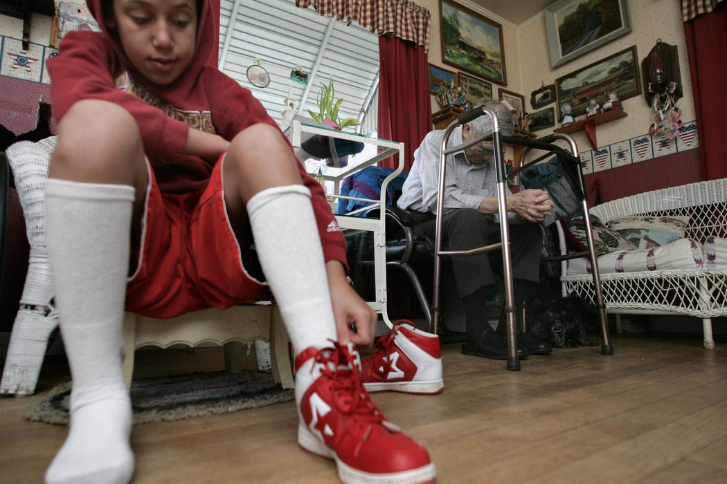 Second Place, Sports Picture Story - Andrea Kjerrumgaard / The Columbus DispatchTerrell Fairrow puts on shoes to go outside to play on a Sunday afternoon as his great grandfahter Leland Rayer rests March 30, 2008, in their Chillicothe home.