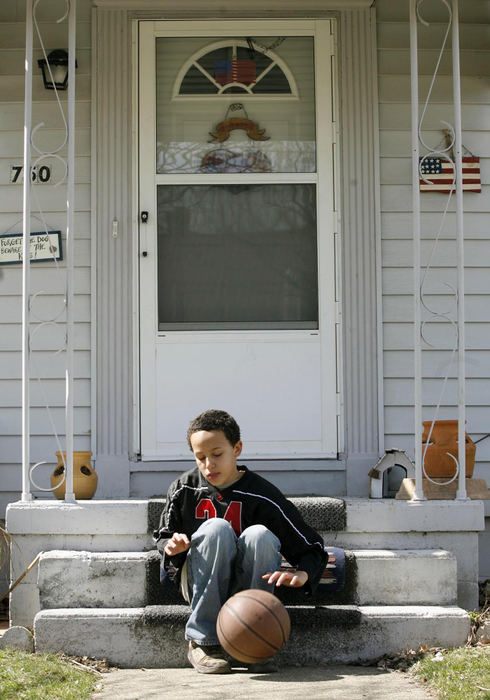 Second Place, Sports Picture Story - Andrea Kjerrumgaard / The Columbus DispatchOn a lazy Sunday afternoon, Terrell Fairrow passes the time dribbling a basketball on his front steps.