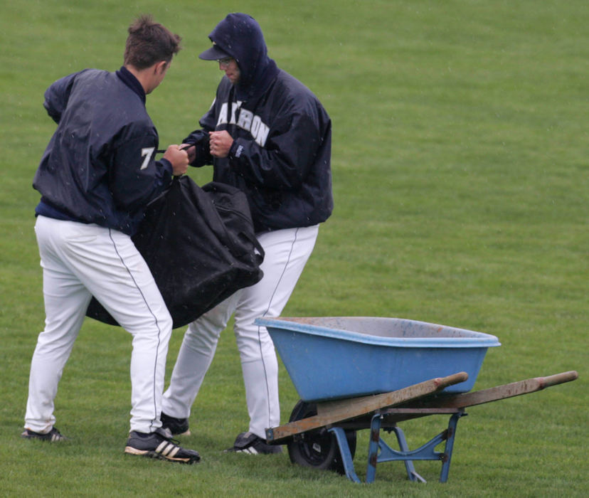 Third Place, Sports Picture Story - Phil Masturzo / Akron Beacon JournalIt appeared that two Akron players were lending a hand to the grounds crew during the rain delay.