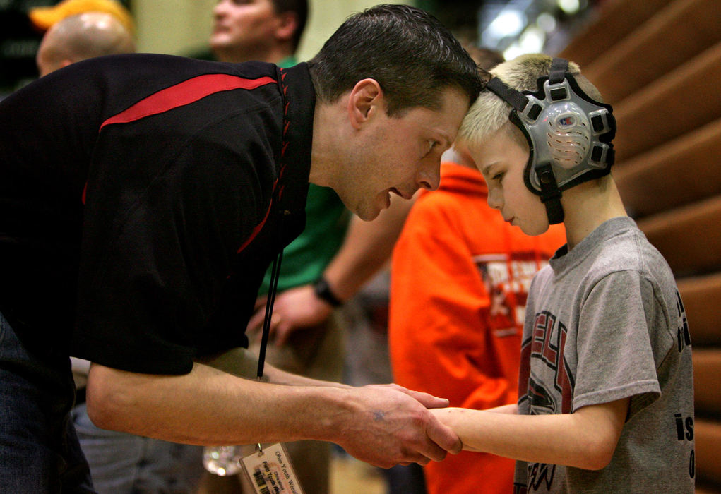 Award of Excellence, Sports Picture Story - Tracy Boulian / The Plain DealerChris Minick (left) coach of Mason Brainard, 10,  gives Brainard a pep talk before the start of his state final 52 lb match. 