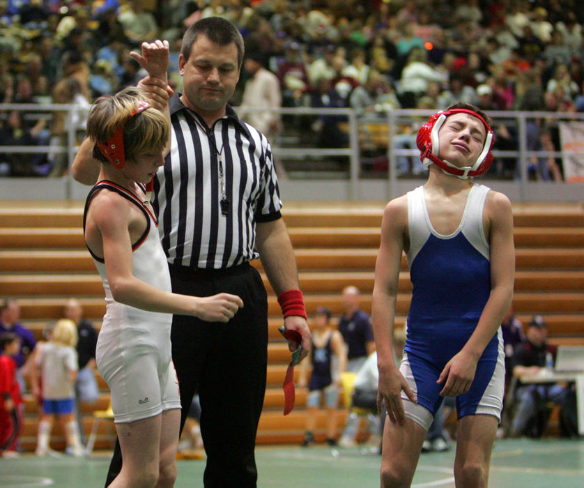 Award of Excellence, Sports Picture Story - Tracy Boulian / The Plain DealerSportsmanship is an important part of wrestling, and the winner and loser must shake hands before leaving the match before the winner is proclaimed. Sometimes, giving up the match officially is a little difficult for some competitors. 