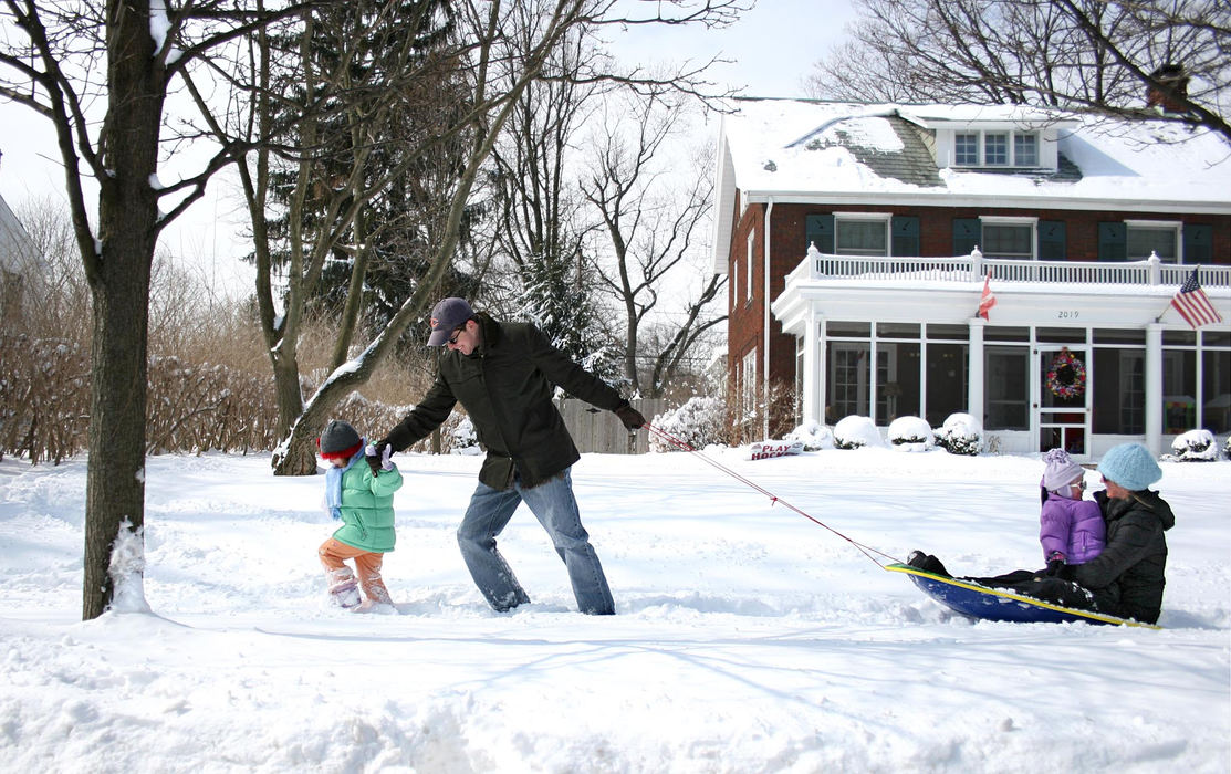 First Place, Team Picture Story - Chris Russell / The Columbus DispatchDeep snow and unplowed sidewalks made sledding the best possible mode of transportation for this family in Upper Arlington.  Darren Richard and daughter Ava Richard, 3, help pull his wife Mary Van Haaften and their other daughter Madeleine Richard back home.  