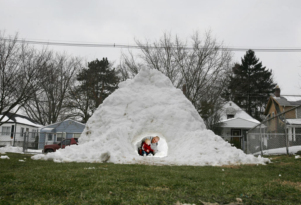 First Place, Team Picture Story - Eric Albrecht / The Columbus DispatchDays after the record snowfall, Tom Greene and his son Owen Greene ,19 months, were able to hide inside their igloo. Tom figured it would be years before he ever saw this much snow again so he wanted to do something memorable. 