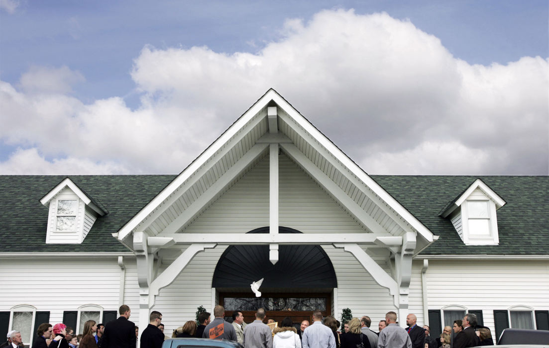 Second Place, Team Picture Story - Shari Lewis / The Columbus DispatchAfter about 300 people attended the funeral of Dianna Sharp, a dove is released outside the Tidd Funeral Home in Hilliard. 