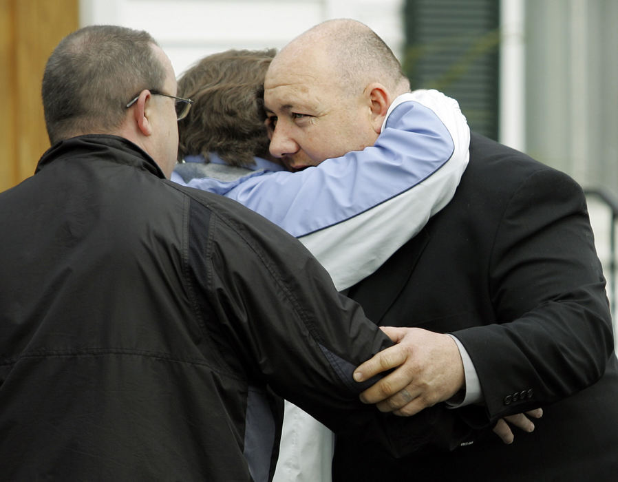 Second Place, Team Picture Story - Shari Lewis / The Columbus DispatchAronn Sharp is consoled after the funeral of his wife Dianna Sharp. Dianna left behind her husband of 18 years and a 10-year-old daughter. 