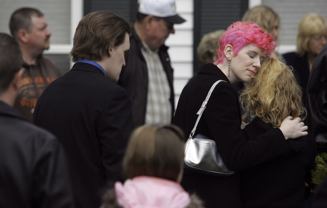 Second Place, Team Picture Story - Shari Lewis / The Columbus DispatchChristian Engle’s aunt gathers outside the funeral of Dianna Sharp. Sharp is credited with saving the life of Engle, who was crossing the street with Sharp when she was hit by the truck.