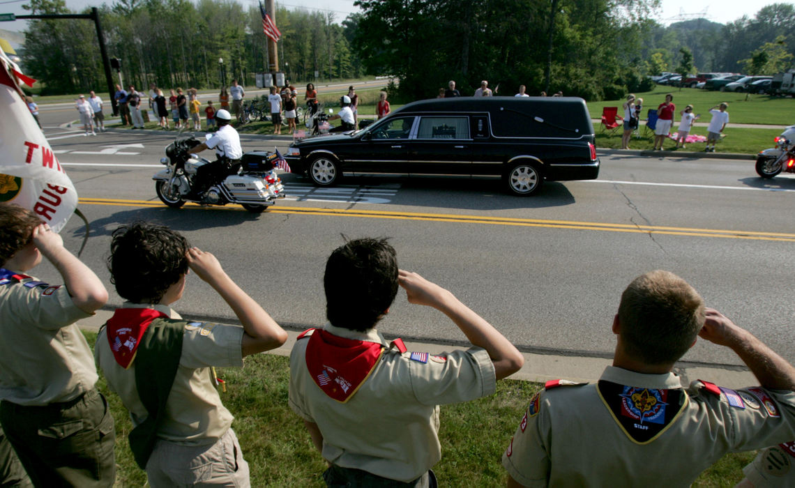 Third Place, Team Picture Story - Marvin Fong / The Plain DealerMembers of Boy Scout Troop 223 from the First Congregational Church of Twinsburg, salute the funeral procession of Twinsburg police officer Joshua Miktarian.