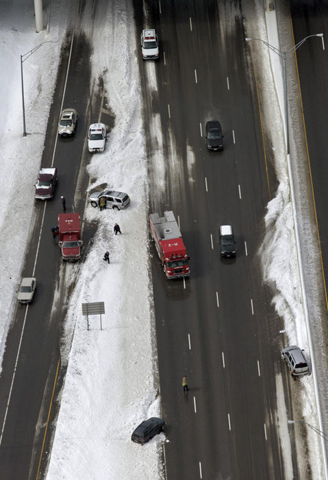 First Place, Team Picture Story - Craig Holman / The Columbus DispatchA record snow fall began on Saturday, March 8 and continued to cause driving problems on Sunday. This multi car accident on I 70 eastbound out of Columbus stopped traffic for hours.