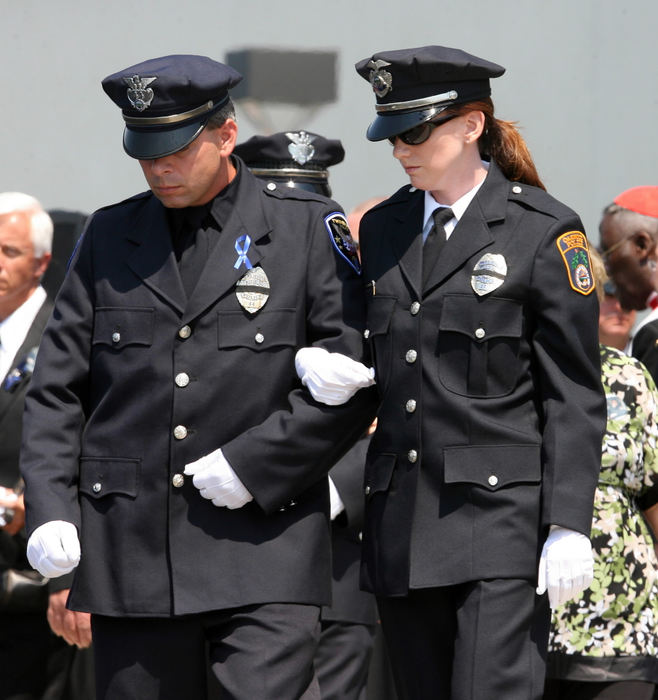 Third Place, Team Picture Story - Lisa DeJong / The Plain DealerHolly Miktarian is escorted to a car after the funeral service.