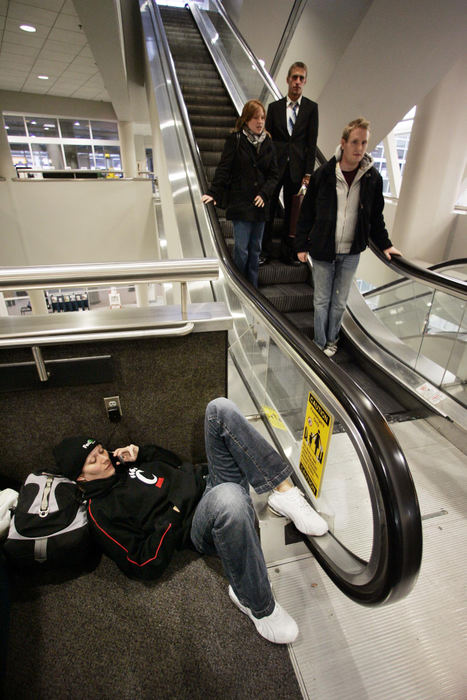 First Place, Team Picture Story - Neal C. Lauron / The Columbus DispatchShannon Keller of Cincinnati gets comfortable for the long wait for a friend to pick her up at Port Columbus, March 7, 2008. Keller was set to fly out to Kansas City for her niece's birthday, but her flight was cancelled. 