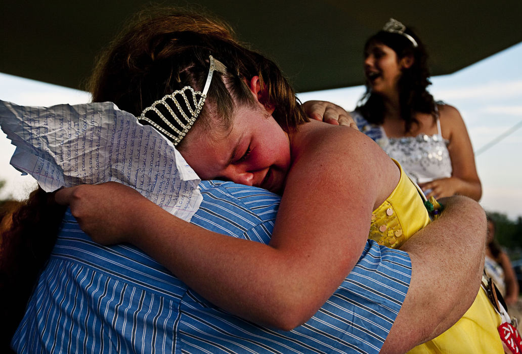 Second Place, Feature - Diego James Robles / Ohio UniversityWhile reading her farewell speech to a large crowd of parents, supporters and local residents, Racheal LeAnn Frost breaks down in tears and falls into the arms of her longtime friend and pageant chairman, Kevin Bennett, on June 6, 2009, in Chauncey. Frost, the 2008-09 Jr. Miss of the Chauncey Dover Spring Festival, said, “I will miss all the girls but especially you Kevin.”