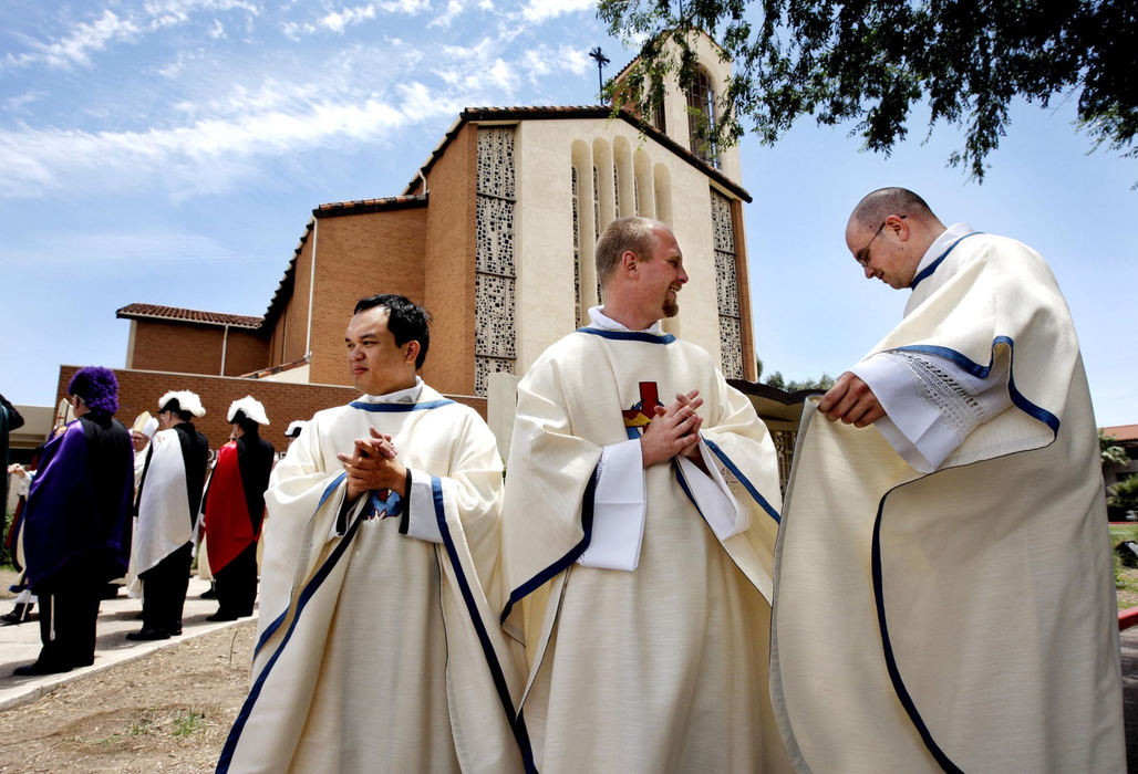 First Place, Feature Picture Story - Fred Squillante / The Columbus DispatchFrom left: Father Thielo Ramirez, Father Will Schmid, and Father Robert Bolding stand outside Saints Simon and Jude Cathedral in Phoenix, Arizona on June 6, 2009 after being ordained as priests.