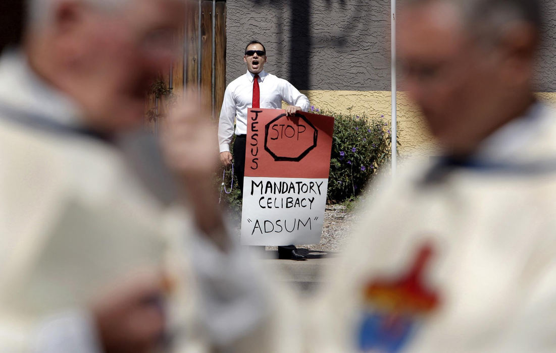 First Place, Feature Picture Story - Fred Squillante / The Columbus DispatchJoe Santa Cruz of Phoenix stands across the street from Saints Simon and Jude Cathedral protesting celibacy for priests on the day of the Robert Bolding's ordination ceremony in Phoenix, Arizona.