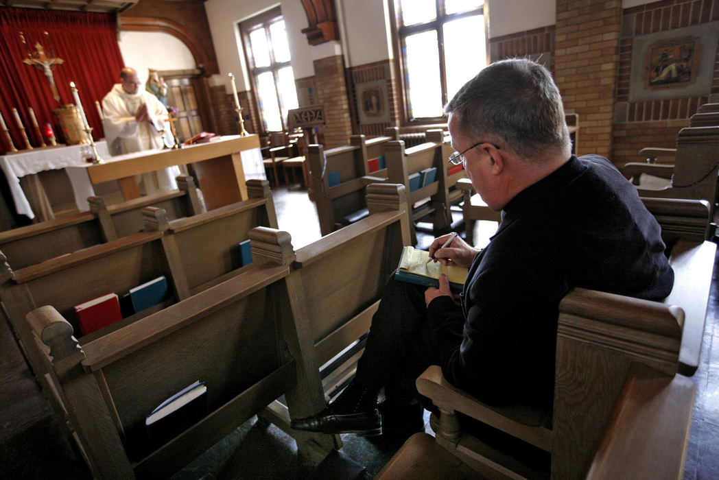 First Place, Feature Picture Story - Fred Squillante / The Columbus DispatchMonsignor Nevin Klinger (right) takes notes as Deacon Robert Bolding, left, practices saying mass. Later, Klinger critiqued Bolding's effort.