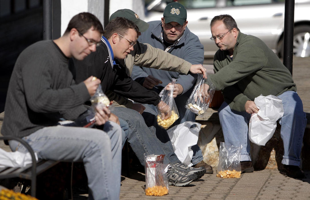 First Place, Feature Picture Story - Fred Squillante / The Columbus DispatchDeacon Robert Bolding (second from right) shares cheese with fellow theology students in Charm on a trip to Amish country. Enjoying a day off from the seminary, the students are, from left: Terry McGowan, Justin Braun, Adam Stimpson, Bolding, and Andrew Budzinski.