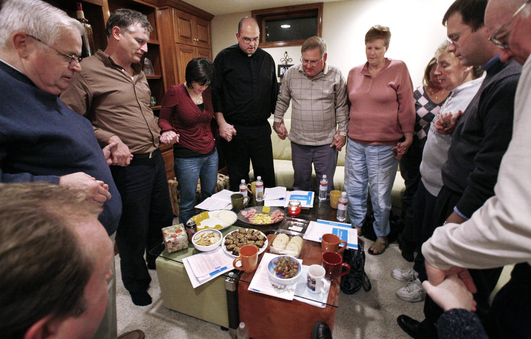 First Place, Feature Picture Story - Fred Squillante / The Columbus DispatchDeacon Robert Bolding (center) leads a group prayer at the end of a prayer meeting at Peggy and Pat O'Donovan's Gahanna home.