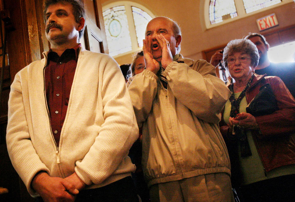 First Place, News Picture Story - Gus Chan / The Plain DealerParishioners from St. Casimir shout at Bishop Richard Lennon after walking out of the closing mass.  Shouts of "go back to Boston" and "Judas" were heard from the crowd.  The mass was interrupted on several occasions with protests and one parishioner cut power to the church's audio system. 