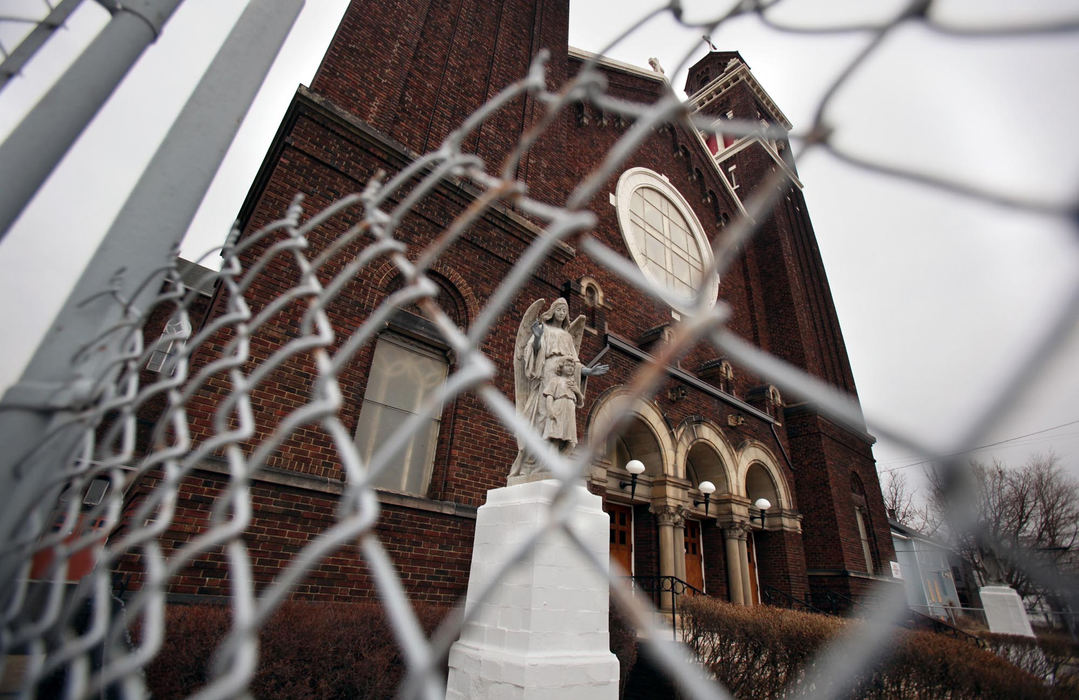 First Place, News Picture Story - Gus Chan / The Plain DealerIn March of 2009, the Catholic Diocese of Catholic announced the closing of 52 churches in the region, leaving parishioners heartbroken.  Though many churches appealed, Bishop Richard Lennon would reverse his decision on only two.  Thirty one of those churches closed by year end, with the remaining 19 by the middle of 2010.  An automated gate and a chain link fence to protect the church in a neighborhood that continues to deteriorate.  