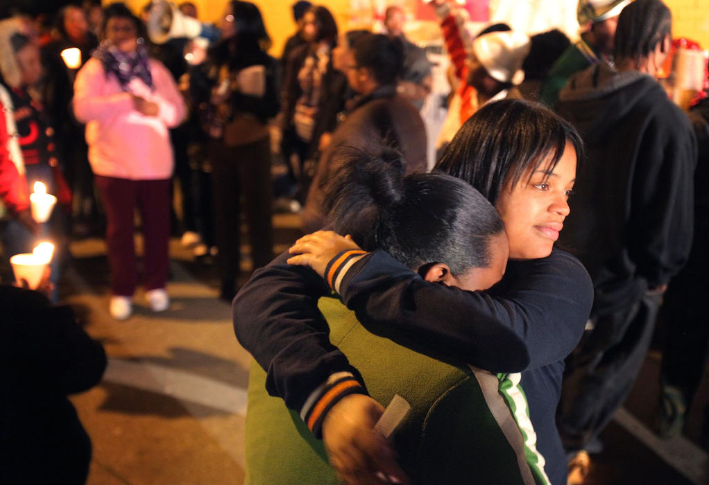 Second Place, News Picture Story - John Kuntz / The Plain DealerMarquilla Bryant (right) consoles her cousin Tina Cook who are cousins of Le' Shaunda Long, one of the 11 identified women in the home of alleged mass murderer Anthony Sowell, during a candlelight vigil at the memorial site on Imperial Avenue in Cleveland, November 12, 2009