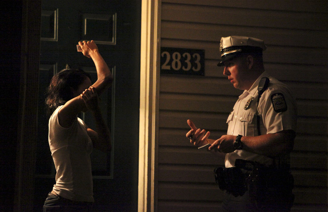 Third Place, News Picture Story - Courtney Hergesheimer / The Columbus DispatchColumbus Police Officer Anthony Sebastiano explains to a South Side woman steps she can take to protect herself from an abusive former boyfriend. The woman shows Sebastiano how the man twisted her arm.