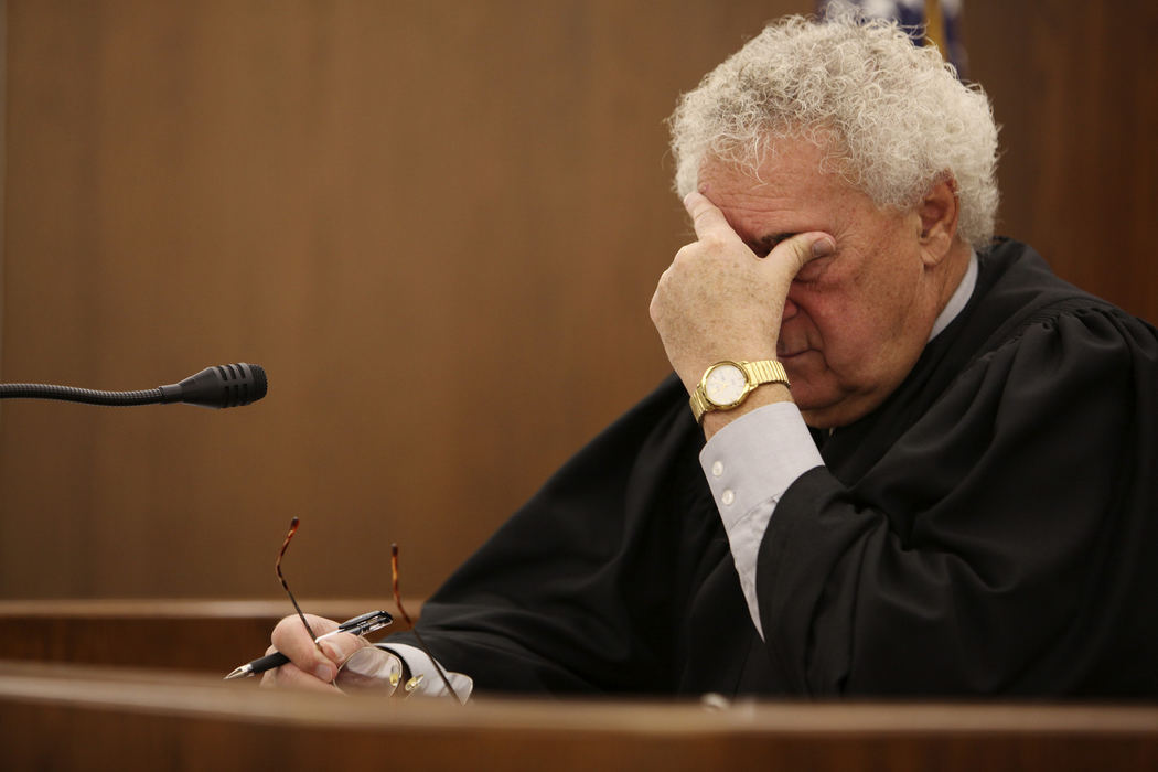 Third Place, News Picture Story - Courtney Hergesheimer / The Columbus DispatchFranklin County Municipal Court Judge, Michael Brandt works his way through domestic violence arraignments, October 8, 2009. 