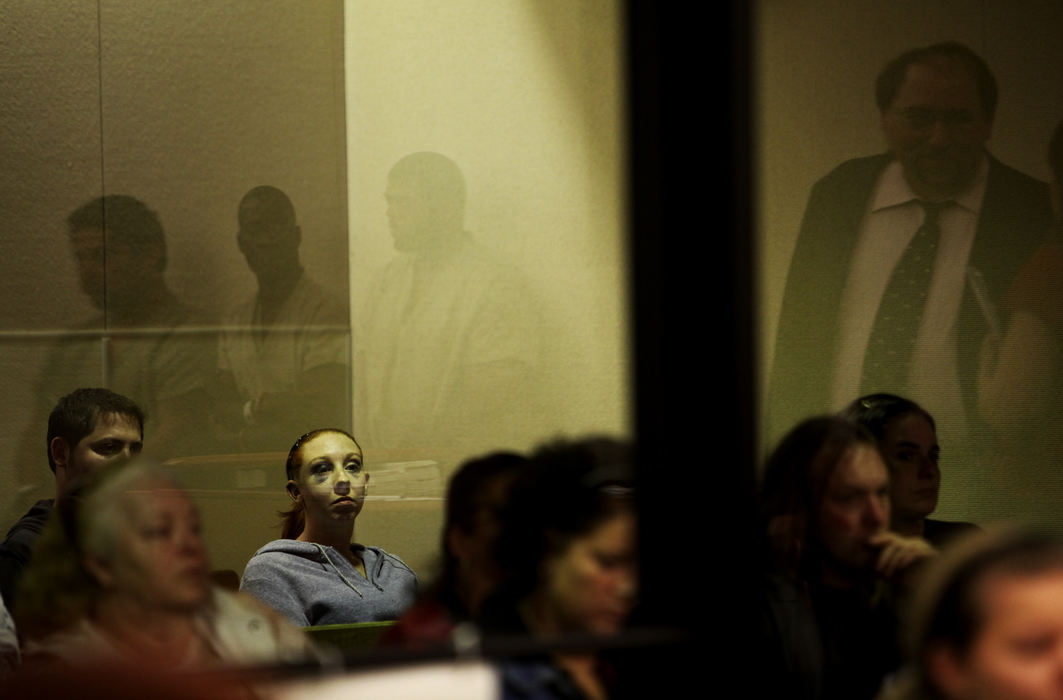 Third Place, News Picture Story - Courtney Hergesheimer / The Columbus DispatchA woman with two black eyes watches from behind a glass divider as domestic violence suspects are arraigned at Franklin County Municipal Court.