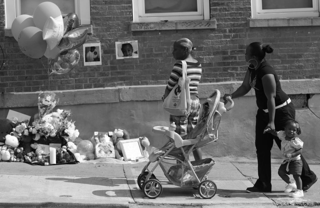 Award of Excellence, News Picture Story - Michael E. Keating / Cincinnati EnquirerShot dead were Noelle Washington, her 9-month-old son, Anthony Jones, and Sharailyn Wright, a 3-year-old girl for whom Washington was babysitting. A neighborhood reacts with a prayer vigil, emotional funeral services including a mime's tribute dance. The killer has not been caught. 