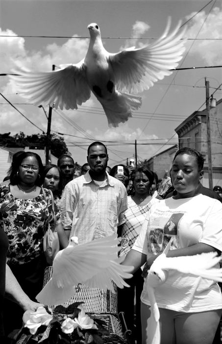 Award of Excellence, News Picture Story - Michael E. Keating / Cincinnati EnquirerDoves are released at the end of a funeral service for Sharailyn Wright who was killed in the shootings. Shot dead were Noelle Washington, her 9-month-old son, Anthony Jones, and Sharailyn Wright, a 3-year-old girl for whom Washington was babysitting. A neighborhood reacts with a prayer vigil, emotional funeral services including a mime's tribute dance. The killer has not been caught. 