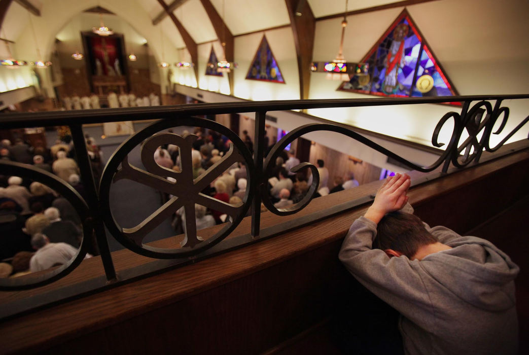 First Place, News Picture Story - Gus Chan / The Plain DealerCollin Klaco folds his hands in prayer during the final mass at St. John the Baptist Church.   Klaco's father, Paul, was an altar boy at the church while growing up.  Bishop Richard Lennon was at the Akron church to preside over the final mass. 