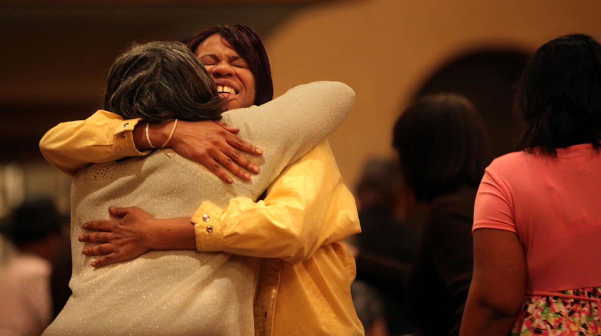 First Place, James R. Gordon Ohio Understanding Award - Gus Chan / The Plain DealerTiffany Skillern (right) hugs her friend, Cynthia Reed after Skillern's two daughter were baptized during the Holy Saturday Vigil.