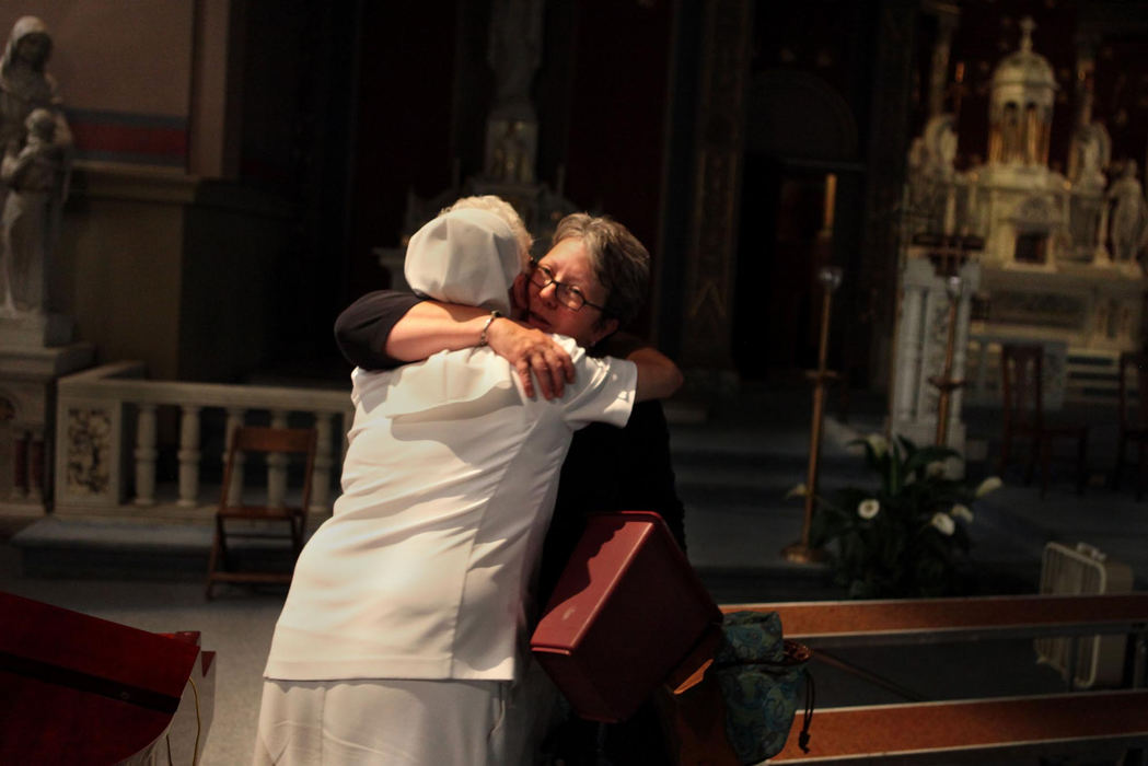 First Place, James R. Gordon Ohio Understanding Award - Gus Chan / The Plain DealerChoir director Martha Talbott (right) gives a hug to Sr. Annette Amendolia (left)  after the final mass at St. Procop Church.  St. Procop closed it's doors for the final time after the morning service.   