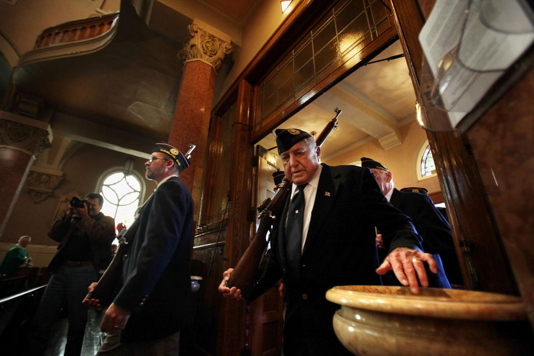 First Place, James R. Gordon Ohio Understanding Award - Gus Chan / The Plain DealerA member of the Polish Legion of American Veterans Post 31 dips his fingers in holy water as the procession makes it's way to the front of the church for the final Polish mass at St. Casimir Church.