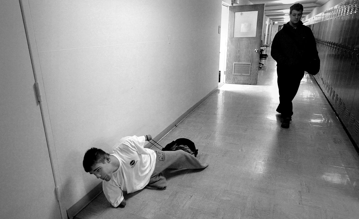 Award of Excellence, Photographer of the Year Large Market - Michael E. Keating / Cincinnati EnquirerNavigating the halls and stairs in an antiquated building is no problem for freshman Dustin Carter.  "I can actually crawl faster than using the wheelchair," he said. Dustin Carter, a former high school standout wrestler from Hillsboro, Ohio overcame long odds with the loss of his limbs to a childhood illness. He is battling now the rigors of life as a freshman at Mt. St. Joseph's College. 