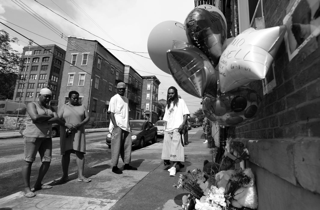 Award of Excellence, Photographer of the Year Large Market - Michael E. Keating / Cincinnati EnquirerShot dead were Noelle Washington, her 9-month-old son, Anthony Jones, and Sharailyn Wright, a 3-year-old girl for whom Washington was babysitting. A neighborhood reacts with a prayer vigil, emotional funeral services including a mime's tribute dance. The killer has not been caught. 