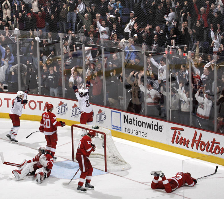 First Place, Photographer of the Year Large Market - Fred Squillante / The Columbus DispatchFans celebrate Columbus Blue Jackets Fredrik Modin's (33) overtime winning goal against the Detroit Red Wings in Columbus. 