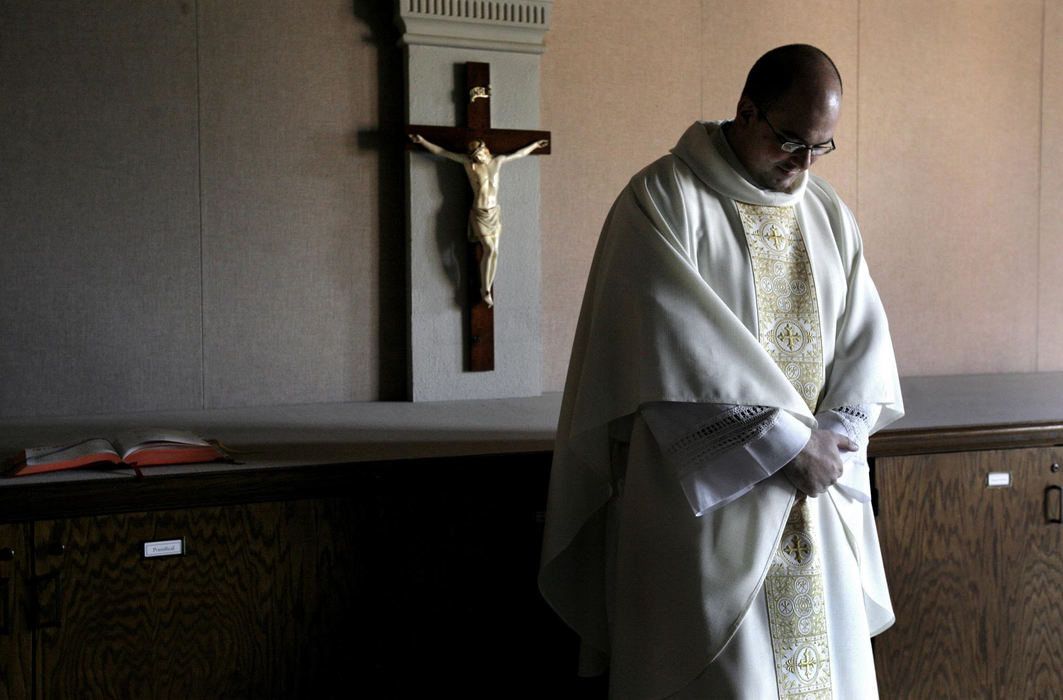 First Place, Photographer of the Year Large Market - Fred Squillante / The Columbus DispatchThe path to the priesthood is one less traveled, as evidenced by a 40-year low number of Roman Catholic clergymen serving a growing church. Robert Bolding, in his final year at a seminary, is one of a few young men to step forward for rigorous training to become a priest.  Deacon Robert Bolding waits for Monsignor Nevin Klinger to arrive so that he can begin a mass practicum class at Pontifical College Josephinum.