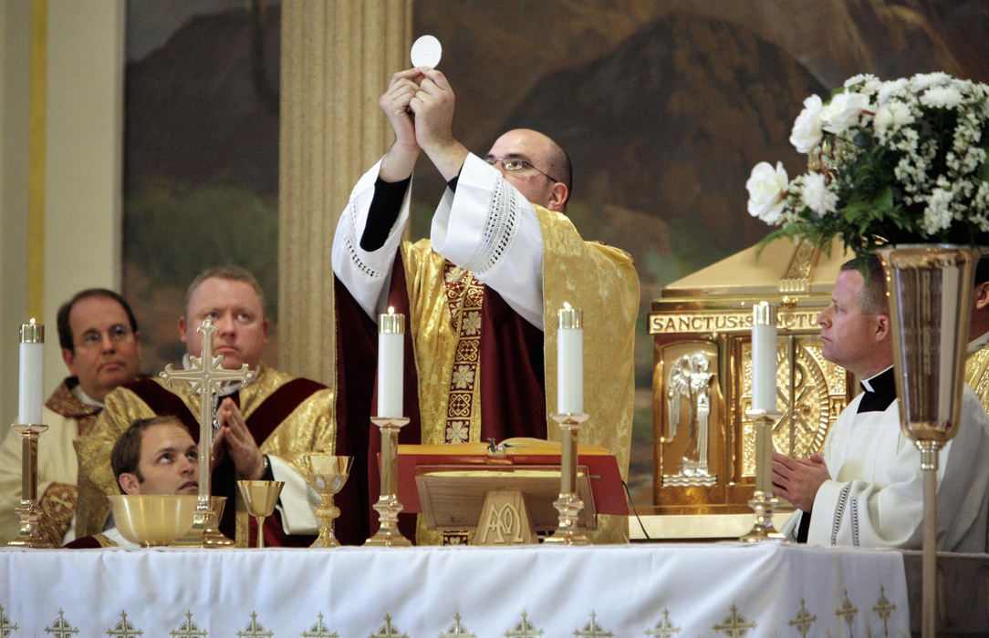 First Place, Photographer of the Year Large Market - Fred Squillante / The Columbus DispatchHaving reached his goal, Father Robert Bolding, center, conducts his first mass as a priest at Saint Thomas The Apostle Catholic Church in Phoenix, Arizona.