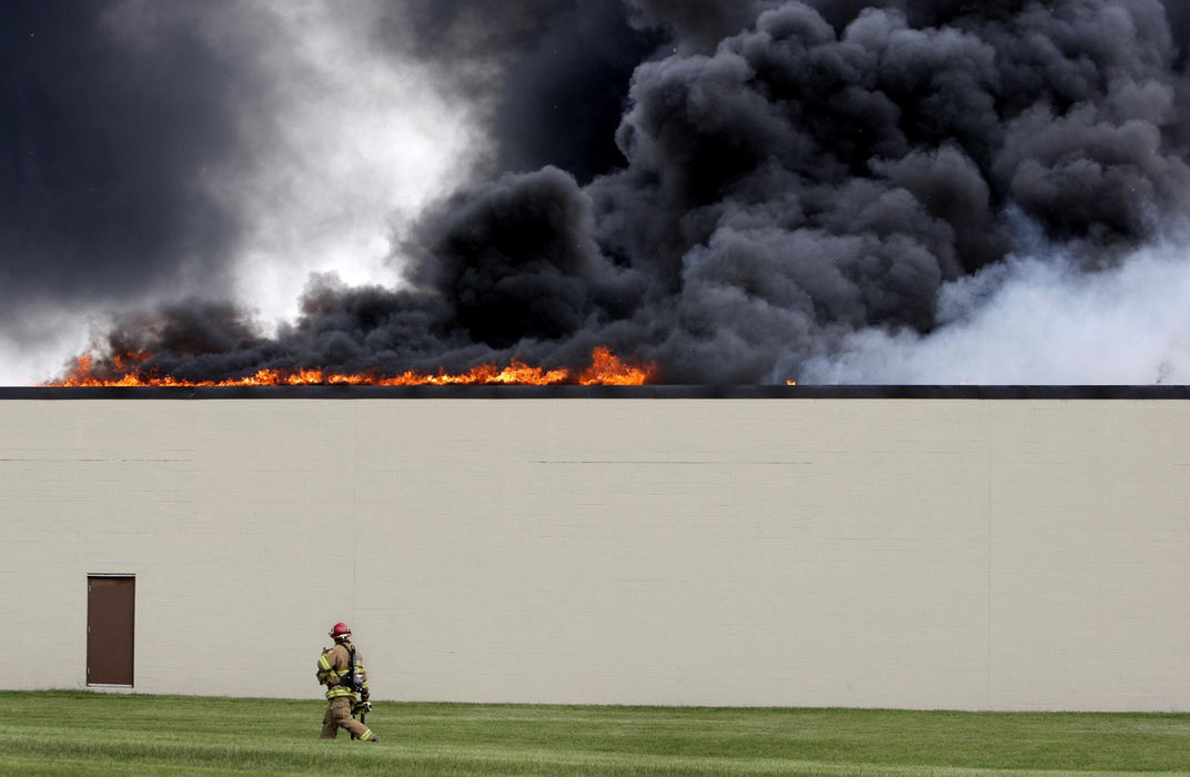 First Place, Photographer of the Year Large Market - Fred Squillante / The Columbus DispatchA firefighter walks along the side wall of HighCom Security in Hilliard, Ohio, as it burns, May 24, 2009. The fire was later determined to be arson.