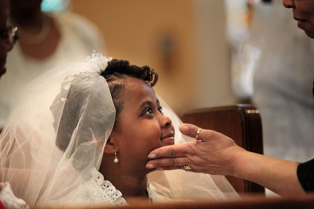 Second Place, Photographer of the Year Large Market - Gus Chan / The Plain DealerLayah Hodges gets a final inspection before she and four other children make their  First Communion  at St. Adalbert Church.  The Cleveland church, linked to the city's first black Catholic congregation, is to close as part of the downsizing of the Cleveland Catholic Diocese.   