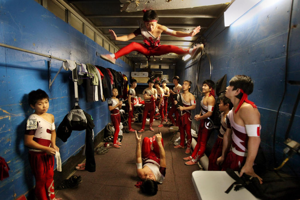 Second Place, Photographer of the Year Large Market - Gus Chan / The Plain DealerThe Chinese Olympic Acrobats warm up in the back of a trailer before performing for the UniverSoul Circus.   The circus, which has been in existence since 1994, is the only black circus in the country. It touts performers from ten different countries.  