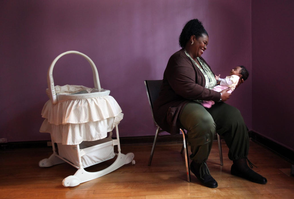 Second Place, Photographer of the Year Large Market - Gus Chan / The Plain DealerTreveya Franklin holds a baby in the nursery of the Hitchcock Center for Women.  Franklin, a former client of the center, has overcome her chemical dependency to become a social worker at the center.  The center will be celebrating it's 30th anniversary this month.  