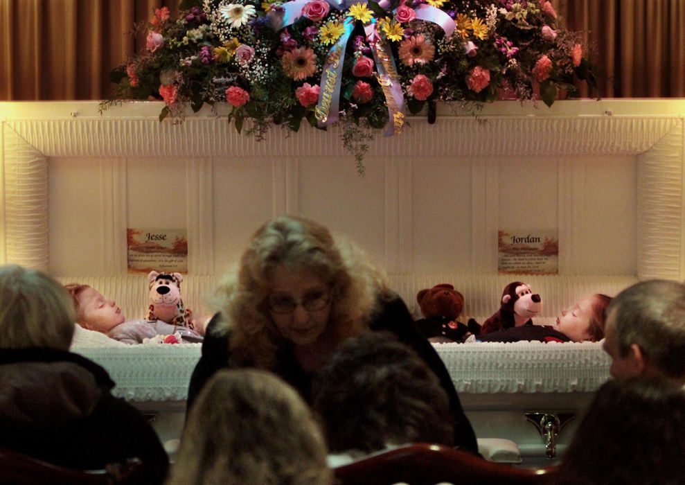 Second Place, Photographer of the Year Large Market - Gus Chan / The Plain DealerFamily members wait for the beginning of the funeral for three-year-old twins Jesse and Jordan Robinson.  Four people, including a five week old baby and the twins, were killed in the house fire, as well as a 26-year-old man.