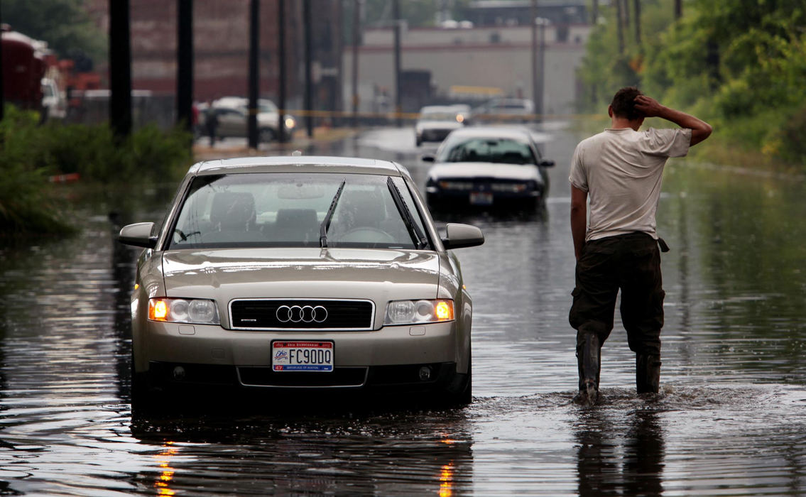 Second Place, Photographer of the Year Large Market - Gus Chan / The Plain DealerA man walks back through standing water after making sure no one was stuck in a car idled by a flash flood on Scranton Rd.  Heavy rains caused flooding throughout the city. 